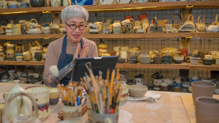 Artist Using Digital Tablet For Online Learning Teaching Of Pottery