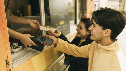 Man doing Online Payment While Buying Food From Concession Stand