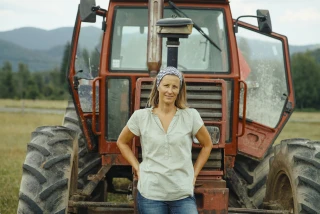 Confident Female Farmer By Tractor