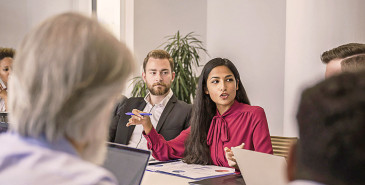 Businessperson speaking in a meeting.