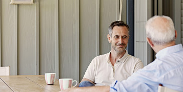 Two people chatting over coffee