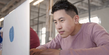 Office worker focusing intently on laptop screen