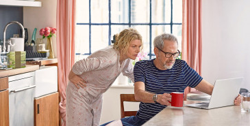 Older couple studying content on laptop