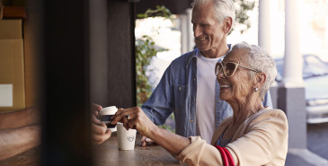 Couple paying for takeaway coffee