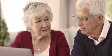 Elderly couple using a laptop