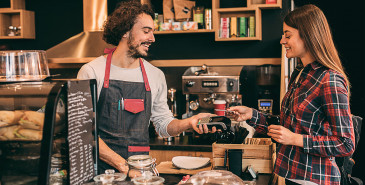 Happy customer purchasing food at a café