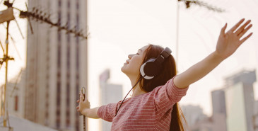 Person listening to music outside with eyes closed