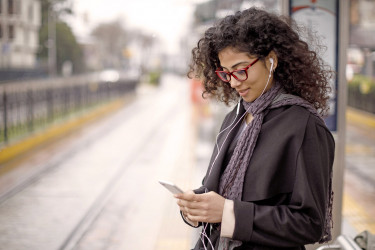 Person listen to music at a train station