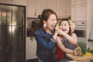 Parent and child playing in the kitchen