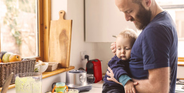 Parent with infant on kitchen bench