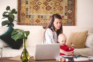 Parent and toddler at table writing in notebook