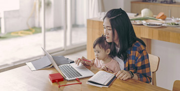 Parent and child in front of laptop working through application