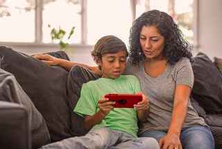 Parent and child looking at smartphone