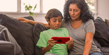 Parent and child looking at smartphone