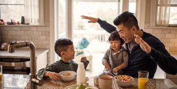 Parent and children sitting having breakfast