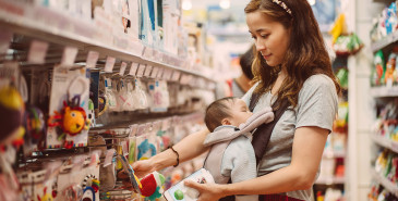 New parent shopping with newborn for baby items