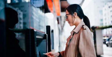 Woman using atm machine