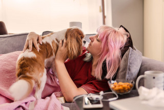 Person with dog on sofa