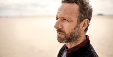 Person looking pensive at the beach