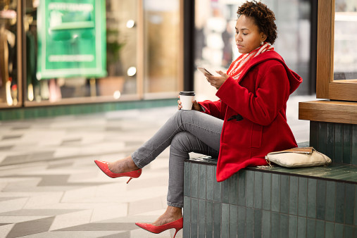 Person sitting having a coffee in a shopping centre
