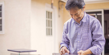 Person outside checking investments on smartphone