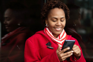 Person smiling while using smartphone