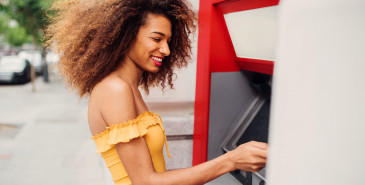 Person taking money out from ATM machine