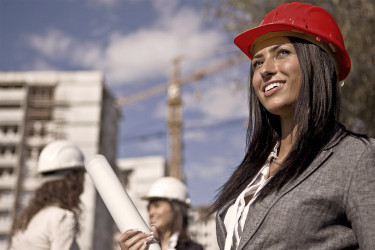 Smiling architect holding rolled paper