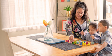 Parent teaching alphabet to children