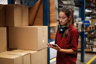 Warehouse worker updating the stock on mobile