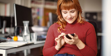 Office worker checking phone