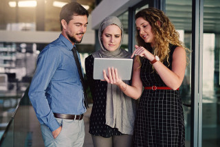 Young business people using a digital tablet in office