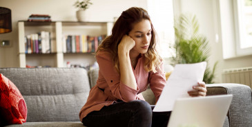 Young woman looking into bills