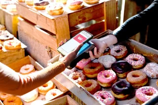 Person buying donuts with phone