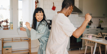 Joyful Female And Male Friend Dancing At Home