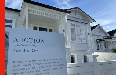 Auction An Auction sign outside a white house for sale