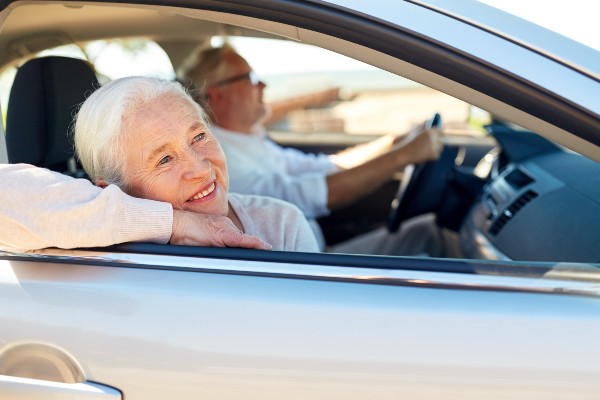 Elderly couple driving in their car