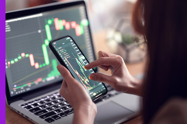 Photo of women checking the currency market on her app.