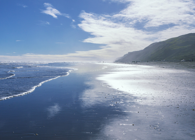 A landscape shot looking down Kariotahi Beach  