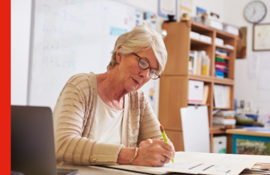 Older woman working Older woman working at desk in office