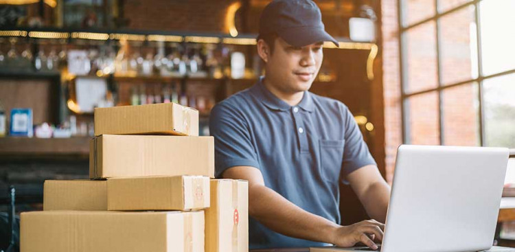 StartingOnlineStorebanner A man working on a laptop in a warehouse