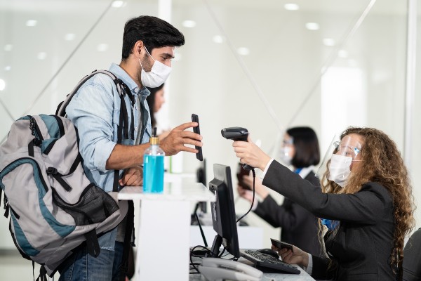 Vaccine pass scan Photo of man scanning vaccine pass at airport