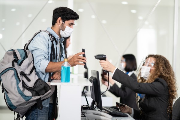 Photo of man scanning vaccine pass at airport