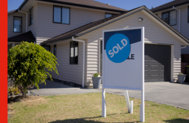 A house with a sold sign out front