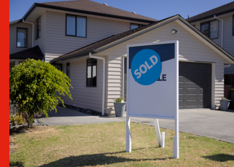 A house with a sold sign out front