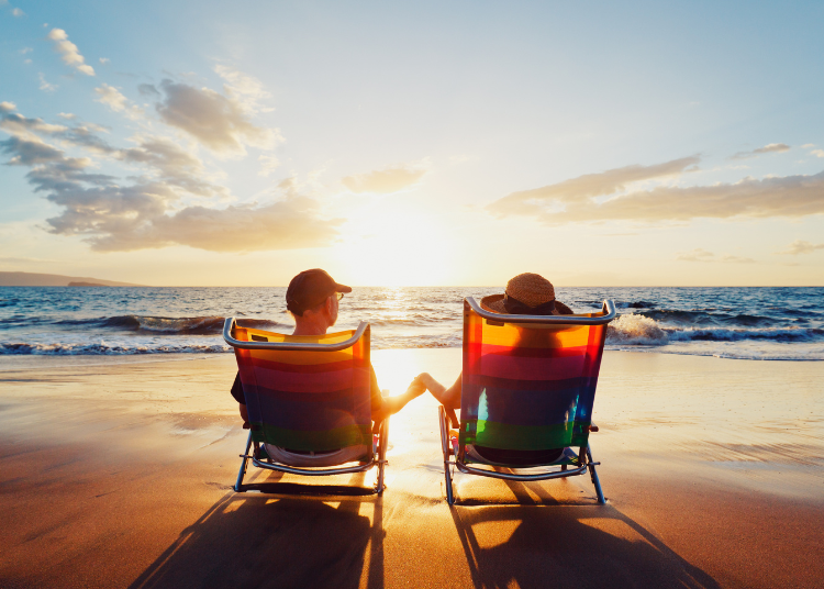 A couple on deckchairs at the beach looking out to the ocean