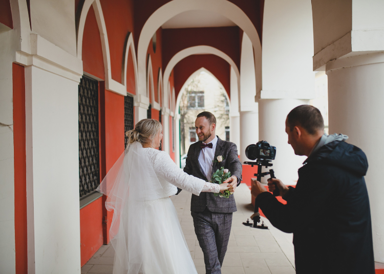 A newly married couple being videoed