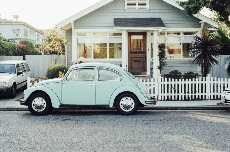 VW Beetle car parked on street outside house
