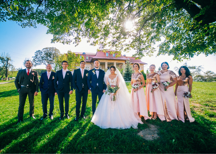 A wedding party with the bride and groom and four groomsmen and four bridesmaids