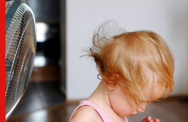 Photo of little girl in front of a standing fan